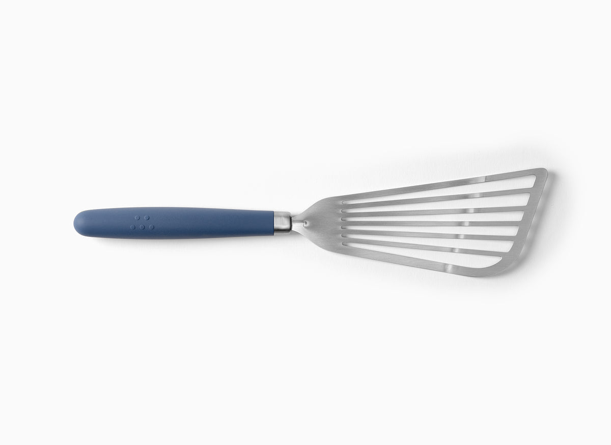 A Blue Misen Metal Fish Spatula on a white background. Shows a slotted and flared metal head attached to a silicone handle.