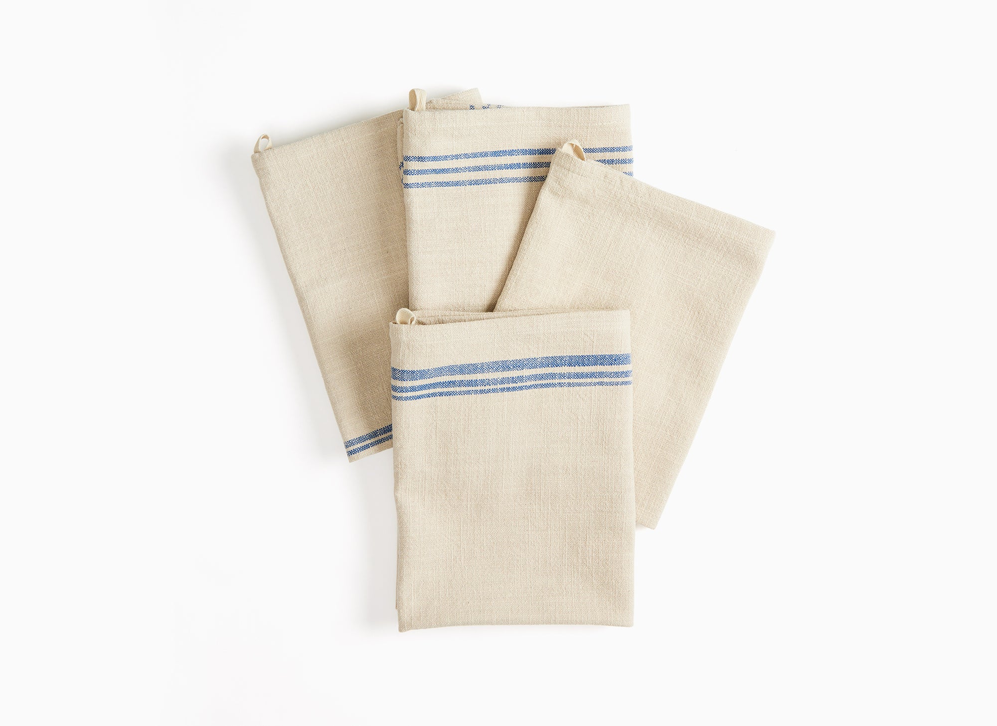 Four folded Misen Towels lie stacked on each other and slightly fanned out on a white background.