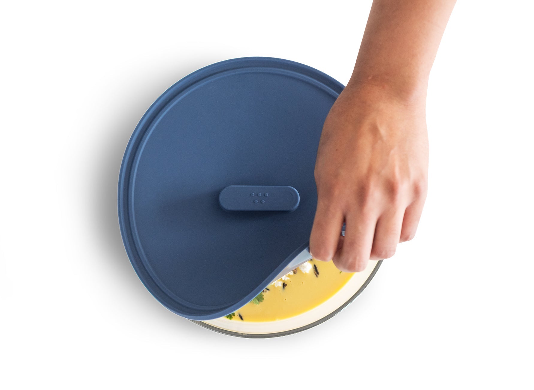 {{8-inch, 10-inch, 12-inch, 8-10-12-inch}} Peeling a Misen Universal Lid off of a bowl of creamy yellow squash soup.