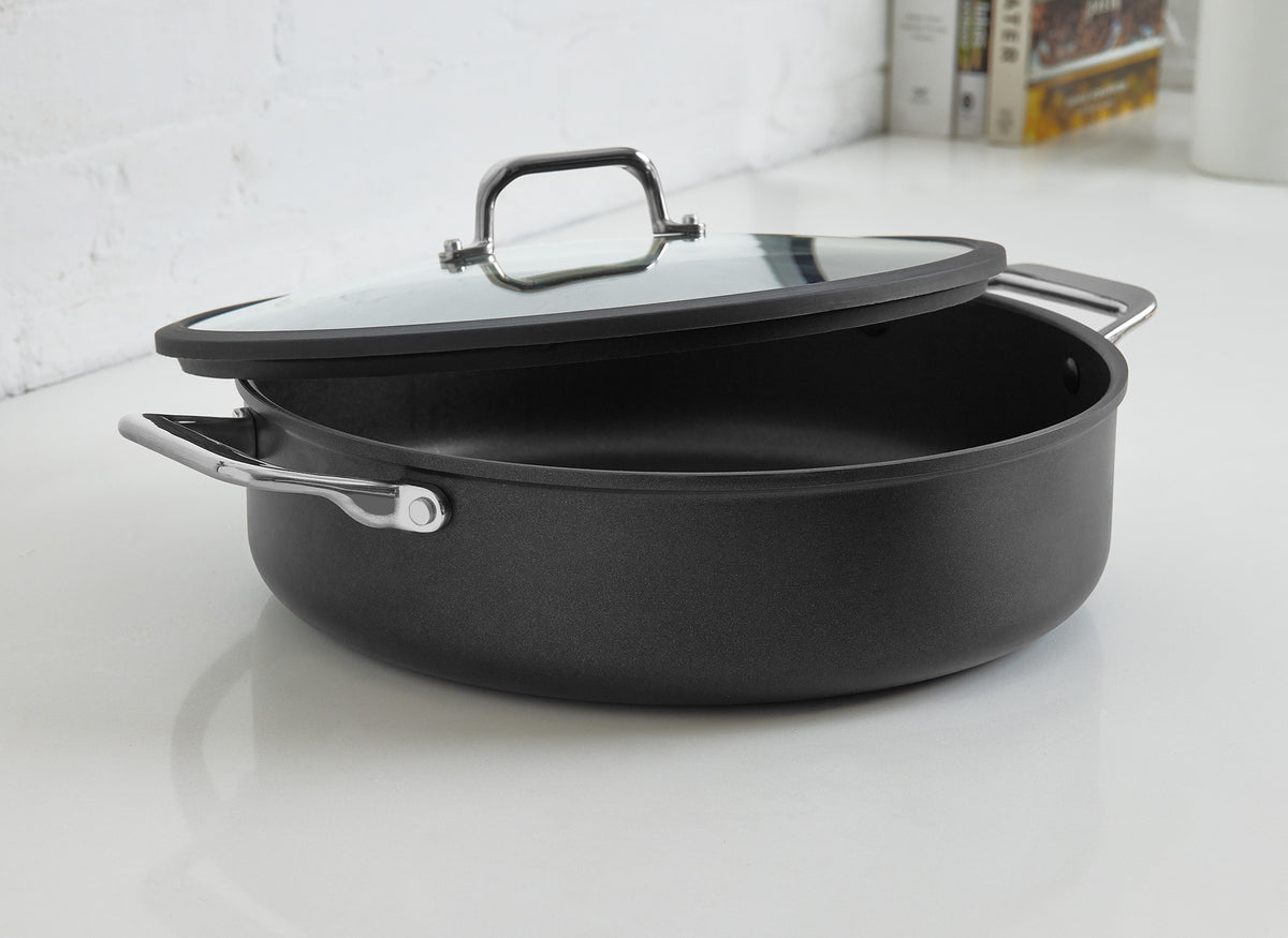 The Misen Nonstick Rondeau sits on a white kitchen countertop with the lid partially on.