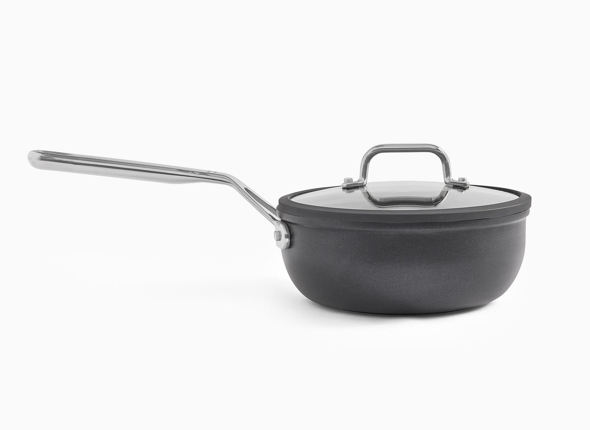 A side view of the Misen 2 QT Nonstick Saucier, with lid on, on a white background.