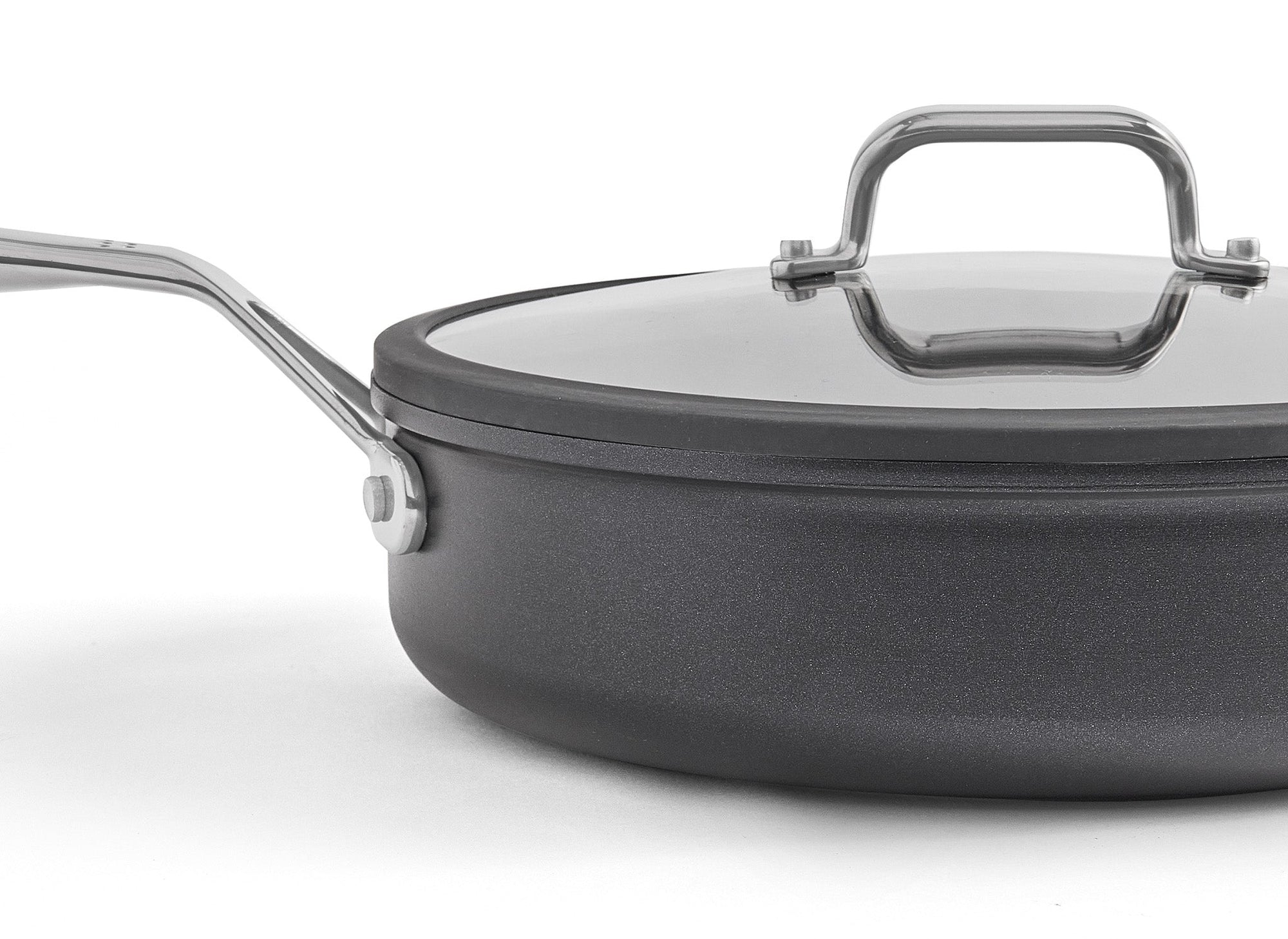 A zoomed in view of the Misen 3 QT Nonstick Sauté Pan on a white background. The left two thirds of the pan are visible.