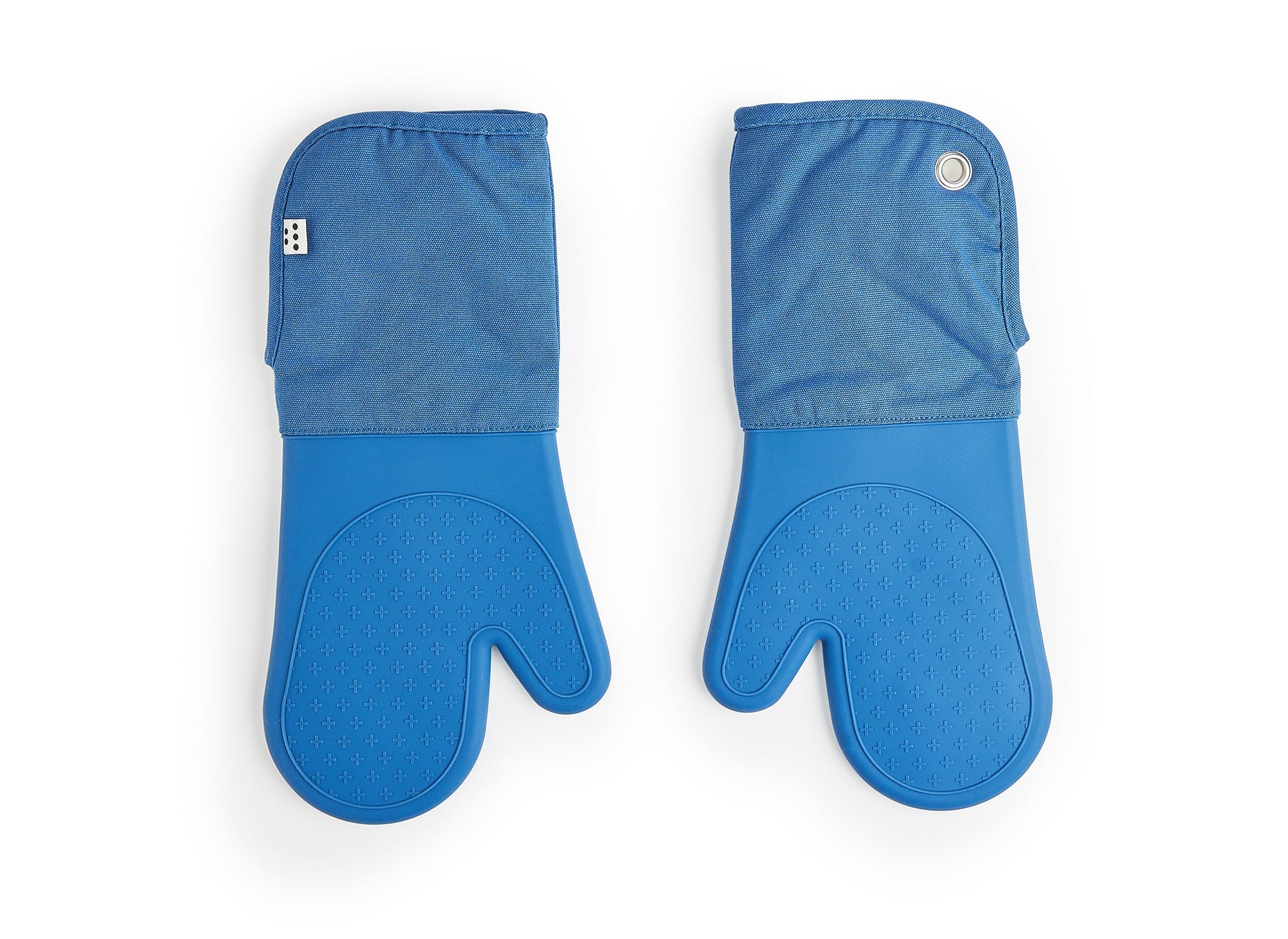 A bird’s eye view of two Misen Oven Mitts next to each other on a white background. The cloth base, silicone-gripped hands and easy-entry design are all clearly visible.
