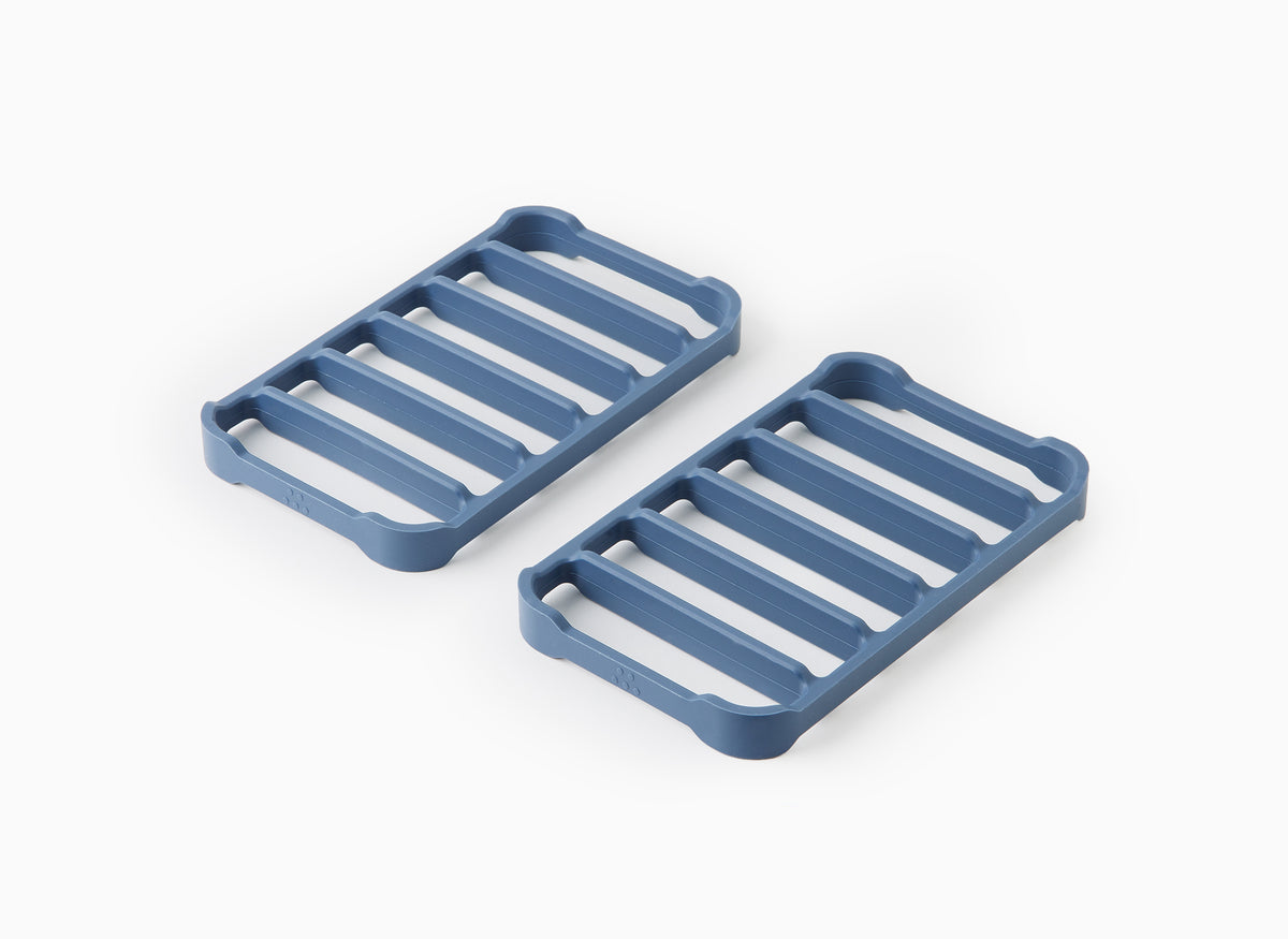 A top view of two blue Misen Silicone Roasting Racks at an angle, laying side by side.