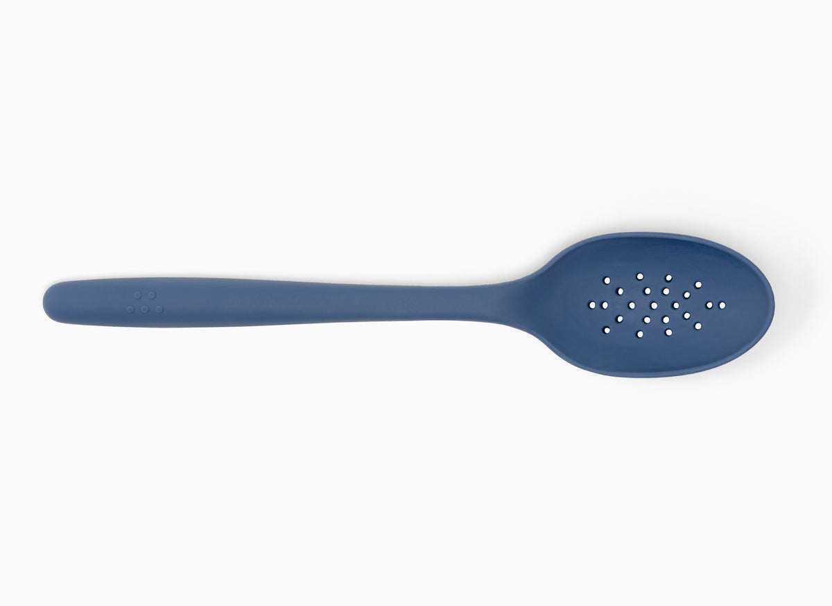 A Blue Misen Slotted Spoon seen from above on a white background.
